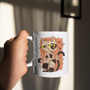 Mummy Cat Funny Halloween Cartoon Mugs, Cool Halloween Coffee Mugs, Cat Mom Cat Dad Coffee Mug, Depicting a Cat Wrapped In Bandages Bat Mugs