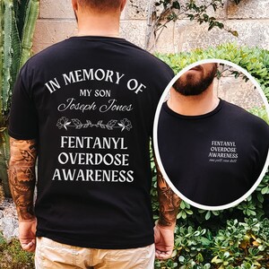 May include: Black t-shirt with white text that reads "In Memory of My Son Joseph Jones Fentanyl Overdose Awareness".