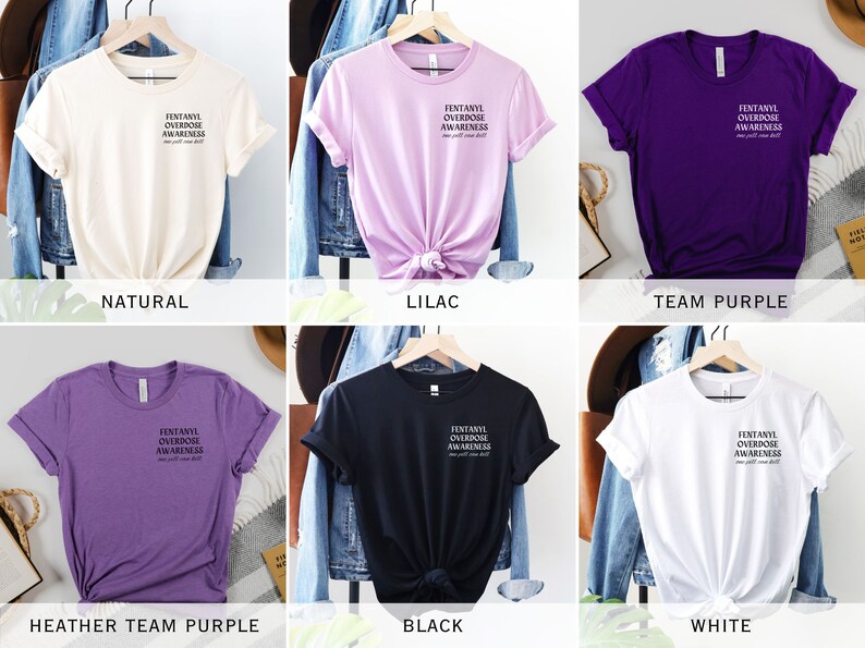 May include: Six different color t-shirts with the text "FENTANYL OVERDOSE AWARENESS" printed on the front. The colors are natural, lilac, team purple, heather team purple, black, and white.