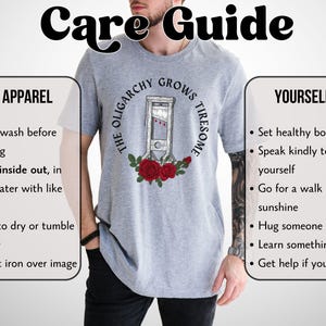 May include: A light gray t-shirt featuring a guillotine illustration surrounded by roses, with the text "THE OLIGARCHY GROWS TIRESOME." The image also includes a care guide with washing instructions and tips for self-care.