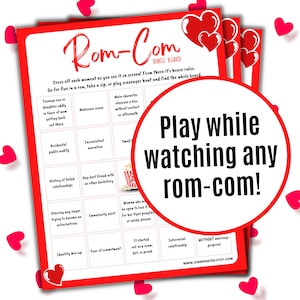 May include: A red and white bingo card with the title "Rom-Com Bingo Board". The card has 25 squares with different rom-com movie tropes listed in each square. The card is surrounded by red hearts.