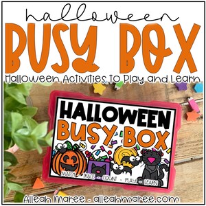 May include: A pink plastic box with the words "Halloween Busy Box" printed on the front. The box contains a variety of Halloween-themed activities for children, such as matching, tracing, counting, playing, and learning. The box is sitting on a wooden surface with a green plant in the background.