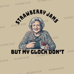 May include: A graphic illustration of an older person with short grey hair wearing a floral cardigan, holding a black handgun in one hand and a jar of strawberry jam in the other. The text reads STRAWBERRY JAMS BUT MY GLOCK DON'T.