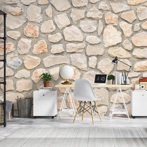 May include: A home office setup with a light wood desk and a laptop showing "4:43". A white chair with wooden legs is in front of the desk. The background is a stone wall. There are white cabinets, a black bookshelf, and a globe.