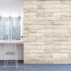May include: A white brick wall with a light brown hue, a white counter with two white metal chairs, and a window with a view of a city skyline.