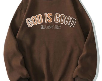 May include: A brown sweatshirt with the text "GOD IS GOOD ALL THE TIME" printed in a gradient of brown and orange.