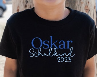 schwarzes T-Shirt „Schulkind 2023“ personalisiert mit Name I Geschenk Einschulung I Outfit erster Schultag I verschiedene Druckfarben