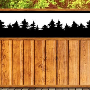 May include: Wooden fence with a black silhouette of a forest against a white background. The fence is made of vertical wooden planks and has a natural wood grain finish. The design is suitable for outdoor decor.