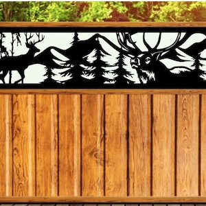 May include: A wooden fence with a black metal insert featuring a silhouette of two deer in a forest setting. The deer are standing in front of a mountain range and pine trees.