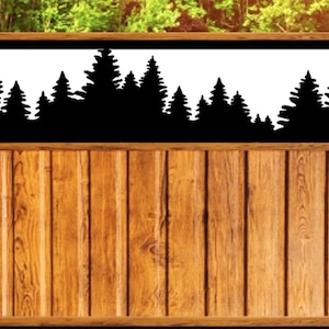 May include: A wooden fence with a black silhouette of a forest scene. The fence is made of vertical wooden planks with a natural wood grain finish. The forest silhouette is set against a white background.