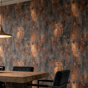 May include: A dining room scene featuring a rustic wooden table and black chairs against a textured wallpaper. The wallpaper has a distressed, industrial look with shades of brown, gray, and orange, creating a warm, inviting atmosphere.