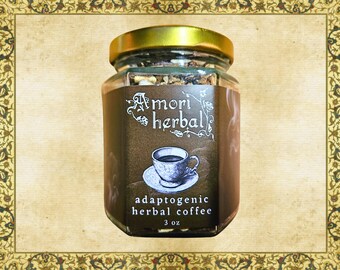 May include: A glass jar filled with brown herbal coffee blend. The label reads "Amori Herbal" and "Adaptogenic Herbal Coffee" with a small illustration of a cup of coffee. The jar is 3 oz.