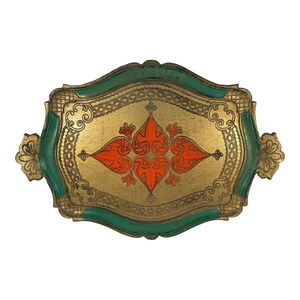 May include: Ornate decorative tray with a gold interior, a green border, and handles. The tray features a symmetrical orange floral design in the center. The tray's edges are detailed with gold filigree.