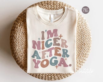 May include: A white t-shirt with the text "I'm Nicer After Yoga" in colorful, retro-style lettering. The text is in a rainbow of colors, including pink, blue, green, and orange.