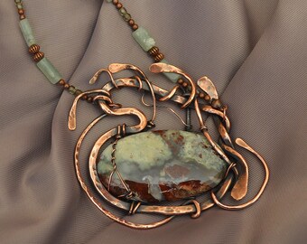 Stone Wind "Mauna Loa" Boho hammered copper Chalcedony volcano picture stone pendant. Necklace is beaded with green Adventurine stone beads.