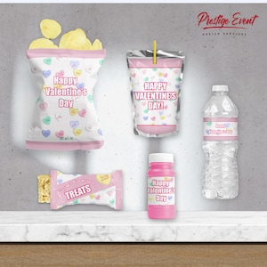 May include: Valentine's Day party favor set with pink and white packaging. The set includes a bag of chips, a juice box, a bottle of water, a small container of bubble solution, and a small bag of treats. All items feature a pink and white heart design with the text "Happy Valentine's Day!"