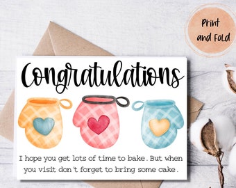 May include: A congratulatory card with a white background and three colorful oven mitts with hearts. The text reads "Congratulations" and "I hope you get lots of time to bake. But when you visit don't forget to bring some cake."