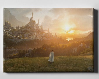 Op de afbeelding: Canvas print van een fantasielandschap met een majestueuze stad met witte torens en gouden accenten, tegen een zonsondergang. Een figuur in een witte mantel staat in een grasveld, met uitzicht op de stad.