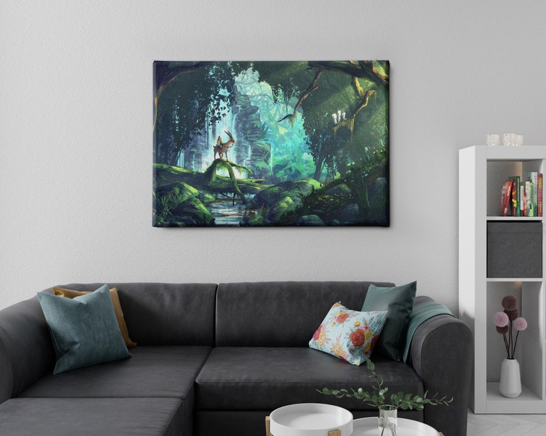 May include: A canvas print depicting a serene forest scene. The artwork features a deer standing on a log in a lush, green environment with a waterfall and vibrant light. The print is displayed above a dark gray sectional sofa with decorative pillows.