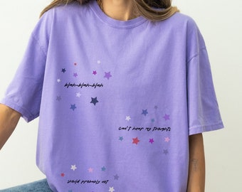 May include: An oversized lavender t-shirt with a colourful star pattern and the text "should probably not", "can't help my friends", and "40/9-40/9-40/9".