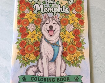 May include: A coloring book titled Remembering the Memphis featuring a central illustration of a grey and white husky dog wearing a blue harness, surrounded by a vibrant border of orange, yellow, and red flowers with green leaves.