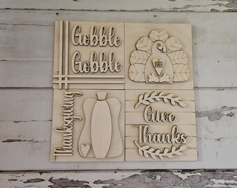 Puede incluir: Cuatro letreros de madera con temas de Acción de Gracias. Los letreros presentan las palabras "Gobble Gobble", un pavo, una calabaza y "Give Thanks".