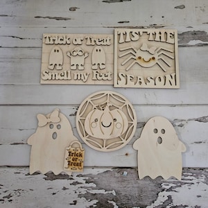 以下が含まれることがあります： 5つの未完成の木製ハロウィーン装飾のセット。装飾には、「トリックオアトリート、私の足を嗅いで」と書かれた看板、「シーズン到来」と書かれた看板、クモ、カボチャ、幽霊が含まれています。