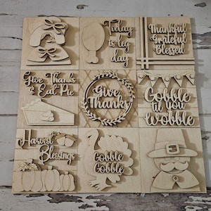 May include: Nine wooden signs with Thanksgiving themes. The signs feature phrases like "Give Thanks", "Gobble Til You Wobble", and "Harvest Blessings".