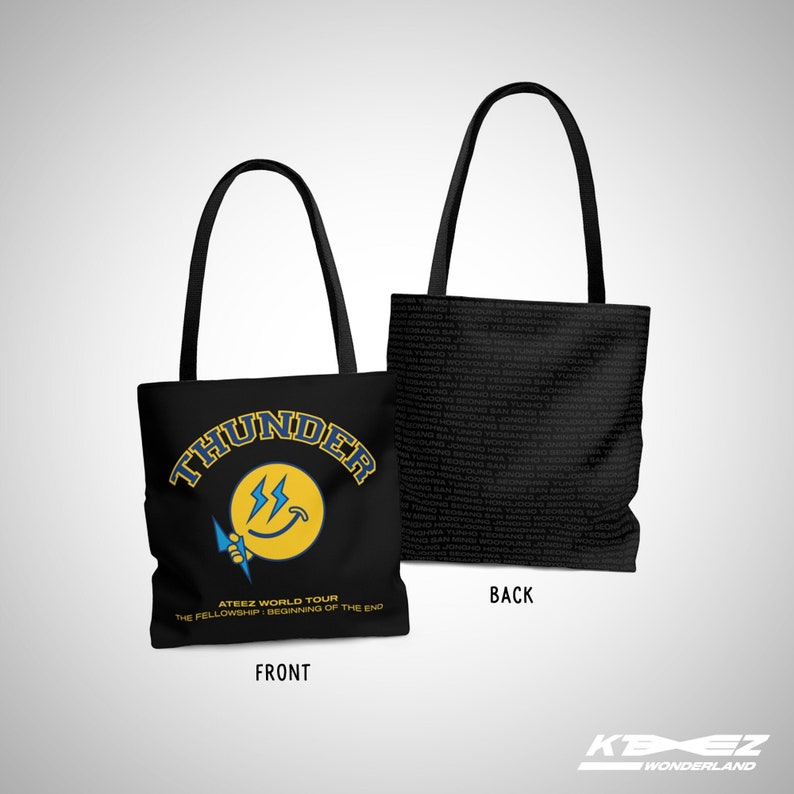 May include: Black tote bag featuring a yellow smiley face with lightning bolts and the text "THUNDER" in blue and yellow. The text "ATEEZ WORLD TOUR THE FELLOWSHIP: BEGINNING OF THE END" is printed below the smiley face. The reverse of the bag is black with the text "BACK" printed in white.