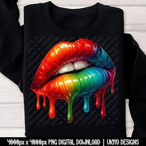May include: Black sweatshirt featuring a vibrant, rainbow-colored lips design. The lips have a glossy, dripping effect, with a spectrum of colors from red to blue. The design includes white teeth and is set against a black background.