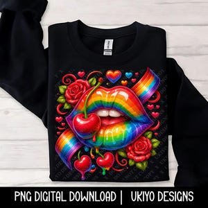 May include: Black sweatshirt featuring a vibrant graphic of rainbow-colored lips with a cherry, roses, hearts, and a rainbow ribbon. The text "PNG DIGITAL DOWNLOAD | UKIYO DESIGNS" is at the bottom.