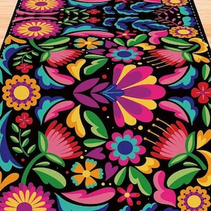 May include: A colorful table runner with a floral pattern. The runner features bright pink, yellow, blue, and green flowers on a black background.