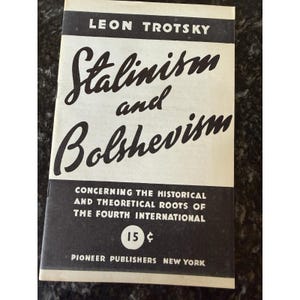 May include: A vintage paperback book titled "Stalinism and Bolshevism" by Leon Trotsky. The cover is black and white, with the title in large, stylized script. The book's price is 15 cents, and it is published by Pioneer Publishers in New York.