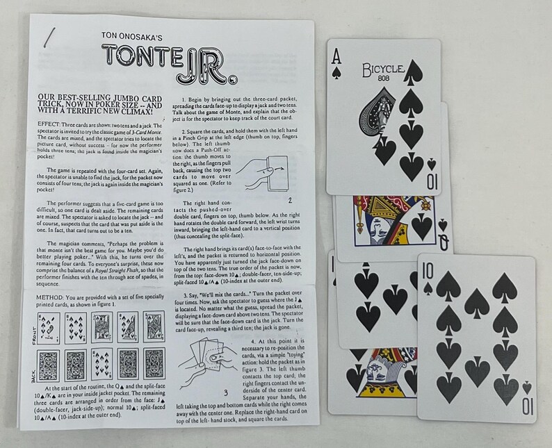 May include: A deck of playing cards with the Bicycle 808 logo, featuring an Ace of Spades, a Queen, and two 10s of Spades. Instructions for a card trick are visible.