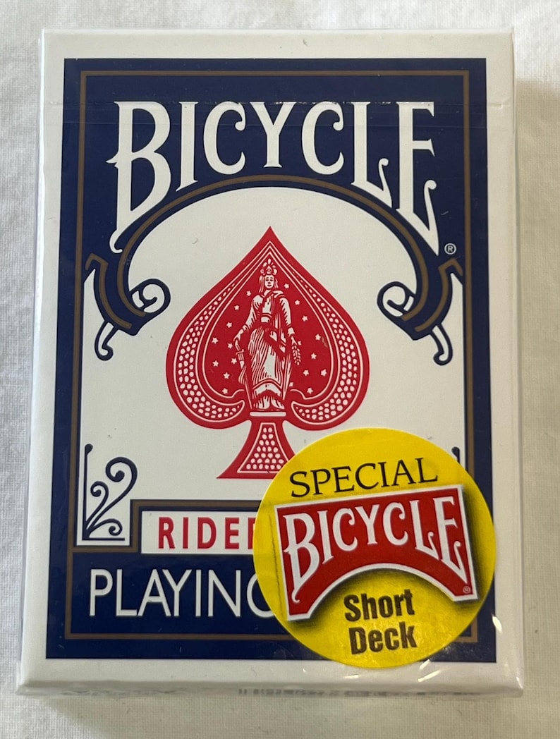 May include: A pack of Bicycle playing cards in a white box with a navy blue border. The pack features the word "BICYCLE" in large white letters, a red spade design, and a yellow sticker that says "SPECIAL BICYCLE Short Deck".