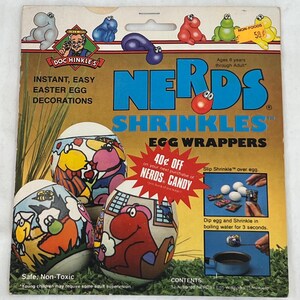 May include: A package of Nerds Shrinkles Egg Wrappers. The package features a colorful illustration of a cartoon character and the text "Nerds Shrinkles Egg Wrappers". The package also includes instructions on how to use the product. The product is safe, non-toxic, and easy to use.