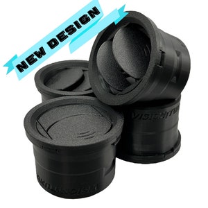 May include: Four black plastic vent covers with a circular design. The vent covers have a raised lip around the edge and a series of small holes for ventilation. The text "VISIONITUS" is printed on the side of the vent covers.