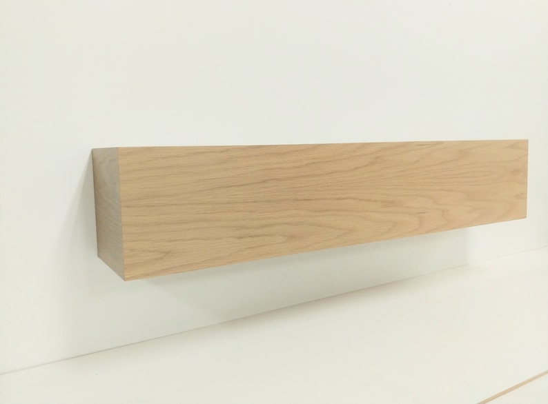 May include: A light wood shelf with a natural finish. The shelf is rectangular and has a smooth surface.