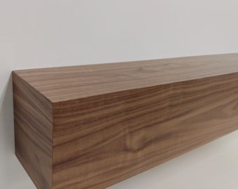 May include: A long, rectangular wooden shelf with a natural wood finish. The shelf is made of solid wood and has a smooth, polished surface.