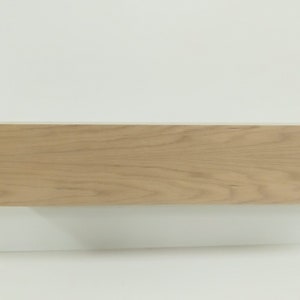 May include: A light wood shelf with a smooth, natural finish. The shelf is rectangular and has a simple, modern design.