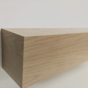 May include: A light brown wooden shelf with a smooth, natural finish. The shelf is rectangular and has a simple, modern design.