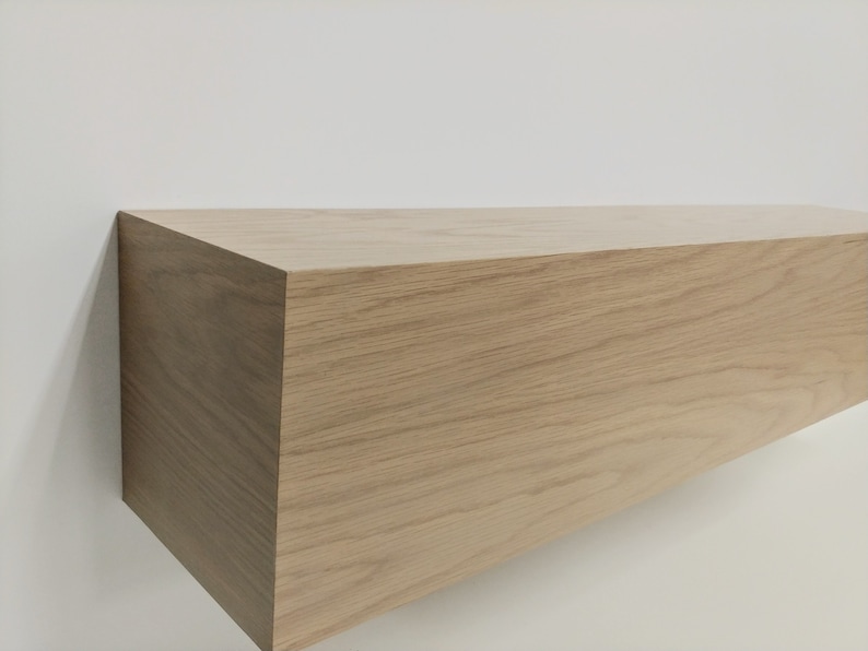 May include: A light brown wooden shelf with a smooth, natural finish. The shelf is rectangular and has a simple, modern design.