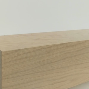 May include: A light wood shelf with a curved edge. The shelf is made of solid wood and has a natural finish.