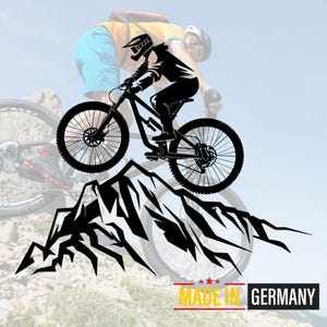 May include: A black and white silhouette of a mountain biker riding a mountain bike up a mountain. The biker is wearing a helmet and goggles. The bike has a suspension fork and disc brakes. The mountain is made up of jagged peaks. The text "MADE IN GERMANY" is at the bottom of the image.