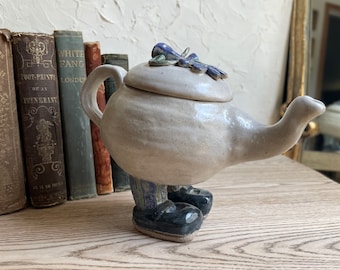 Vintage handmade studio pottery of a walking Tea pot with blue socks and shoes