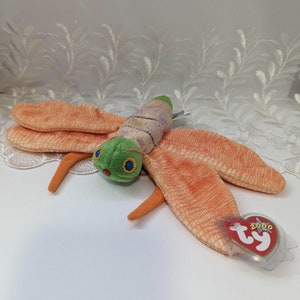 May include: Orange and green plush toy dragonfly with a Ty tag that says "2000".