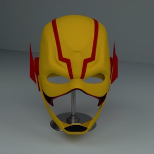 May include: A yellow superhero mask with red detailing. The mask has a streamlined design with red lightning bolt-shaped details on the forehead and red side wings. The eye openings are large, and the lower part of the mask is black.