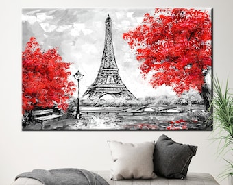 May include: Black, white, and red canvas art print of the Eiffel Tower in Paris. The artwork features the iconic tower in grayscale, with vibrant red trees on either side. A lamp post and bridge are also visible.