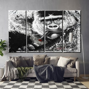 May include: A multi-panel canvas art piece featuring a black and white gorilla smoking a cigar. The artwork has a splattered paint effect, with the gorilla's face and hand in sharp focus. The cigar has a red tip.
