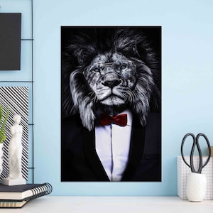 May include: A black and white photo of a lion wearing a black suit and a red bow tie. The lion is wearing glasses and has a serious expression on its face.